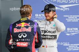 (L to R): second placed Sebastian Vettel (GER) Red Bull Racing with pole sitter Nico Rosberg (GER) Mercedes AMG F1 in qualifying parc ferme. 05.07.2014. Formula 1 World Championship, Rd 9, British Grand Prix, Silverstone, England, Qualifying Day.