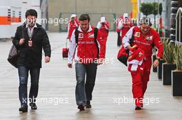 Fernando Alonso (ESP) Ferrari (Centre) with Luis Garcia Abad (ESP) Driver Manager (Left) and Fabrizio Borra (ESP) Ferrari Physio (Right). 05.07.2014. Formula 1 World Championship, Rd 9, British Grand Prix, Silverstone, England, Qualifying Day.