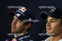 Pole sitter Nico Rosberg (GER) Mercedes AMG F1 (Right) and second placed Sebastian Vettel (GER) Red Bull Racing in the FIA Press Conference. 05.07.2014. Formula 1 World Championship, Rd 9, British Grand Prix, Silverstone, England, Qualifying Day.