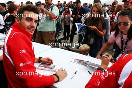 Jules Bianchi (FRA) Marussia F1 Team signs autographs for the fans. 05.07.2014. Formula 1 World Championship, Rd 9, British Grand Prix, Silverstone, England, Qualifying Day.