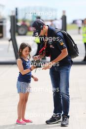 Daniel Ricciardo (AUS) Red Bull Racing signs an autograph for a young fan.  03.07.2014. Formula 1 World Championship, Rd 9, British Grand Prix, Silverstone, England, Preparation Day.