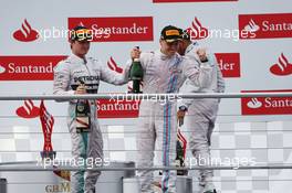 Valtteri Bottas (FIN) Williams (Centre) celebrates his second position on the podium with race winner Nico Rosberg (GER) Mercedes AMG F1 (Left) and third placed Lewis Hamilton (GBR) Mercedes AMG F1 (Right). 20.07.2014. Formula 1 World Championship, Rd 10, German Grand Prix, Hockenheim, Germany, Race Day.