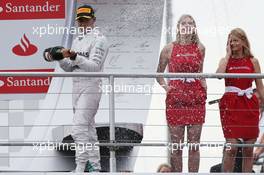 Lewis Hamilton (GBR) Mercedes AMG F1 celebrates his third position with the champagne on the podium. 20.07.2014. Formula 1 World Championship, Rd 10, German Grand Prix, Hockenheim, Germany, Race Day.