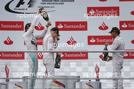 Valtteri Bottas (FIN) Williams (Centre) celebrates his second position on the podium with race winner Nico Rosberg (GER) Mercedes AMG F1 (Left) and third placed Lewis Hamilton (GBR) Mercedes AMG F1 (Right). 20.07.2014. Formula 1 World Championship, Rd 10, German Grand Prix, Hockenheim, Germany, Race Day.