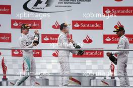 Valtteri Bottas (FIN) Williams (Centre) celebrates his second position on the podium with race winner Nico Rosberg (GER) Mercedes AMG F1 (Left) and third placed Lewis Hamilton (GBR) Mercedes AMG F1 (Right). 20.07.2014. Formula 1 World Championship, Rd 10, German Grand Prix, Hockenheim, Germany, Race Day.