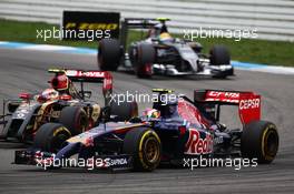 Daniil Kvyat (RUS) Scuderia Toro Rosso STR9 and Pastor Maldonado (VEN) Lotus F1 E21 battle for position. 20.07.2014. Formula 1 World Championship, Rd 10, German Grand Prix, Hockenheim, Germany, Race Day.