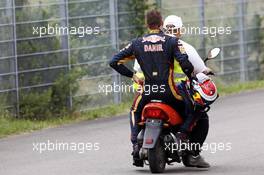 Race retiree Daniil Kvyat (RUS) Scuderia Toro Rosso returns back to the pits on the back of a scooter. 20.07.2014. Formula 1 World Championship, Rd 10, German Grand Prix, Hockenheim, Germany, Race Day.