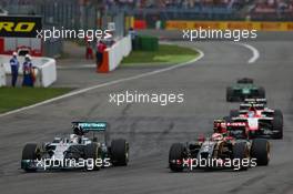 Lewis Hamilton (GBR) Mercedes AMG F1 W05 and Pastor Maldonado (VEN) Lotus F1 E21 battle for position. 20.07.2014. Formula 1 World Championship, Rd 10, German Grand Prix, Hockenheim, Germany, Race Day.