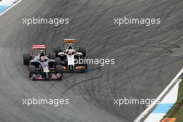 Daniil Kvyat (RUS) Scuderia Toro Rosso STR9 and Sergio Perez (MEX) Sahara Force India F1 VJM07 make contact whilst battling for position. 20.07.2014. Formula 1 World Championship, Rd 10, German Grand Prix, Hockenheim, Germany, Race Day.