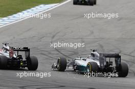 Jenson Button (GBR) McLaren MP4-29 and Lewis Hamilton (GBR) Mercedes AMG F1 W05 make contact as they battle for position. 20.07.2014. Formula 1 World Championship, Rd 10, German Grand Prix, Hockenheim, Germany, Race Day.