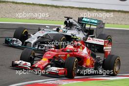 Kimi Raikkonen (FIN) Ferrari F14-T and Lewis Hamilton (GBR) Mercedes AMG F1 W05 battle for position. 20.07.2014. Formula 1 World Championship, Rd 10, German Grand Prix, Hockenheim, Germany, Race Day.