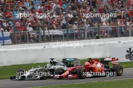 Kimi Raikkonen (FIN) Ferrari F14-T and Lewis Hamilton (GBR) Mercedes AMG F1 W05 battle for position. 20.07.2014. Formula 1 World Championship, Rd 10, German Grand Prix, Hockenheim, Germany, Race Day.