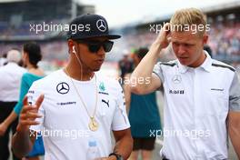 (L to R): Lewis Hamilton (GBR) Mercedes AMG F1 with Kevin Magnussen (DEN) McLaren on the drivers parade. 20.07.2014. Formula 1 World Championship, Rd 10, German Grand Prix, Hockenheim, Germany, Race Day.