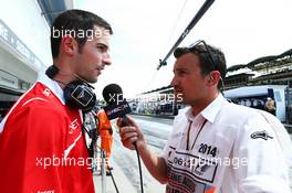 (L to R): Alexander Rossi (USA) Marussia F1 Team Reserve Driver with Will Buxton (GBR) NBS Sports Network TV Presenter. 25.07.2014. Formula 1 World Championship, Rd 11, Hungarian Grand Prix, Budapest, Hungary, Practice Day.