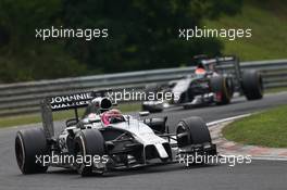 Jenson Button (GBR) McLaren MP4-29 leads Adrian Sutil (GER) Sauber C33. 27.07.2014. Formula 1 World Championship, Rd 11, Hungarian Grand Prix, Budapest, Hungary, Race Day.