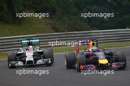 Sebastian Vettel (GER) Red Bull Racing RB10 and Lewis Hamilton (GBR) Mercedes AMG F1 W05. 27.07.2014. Formula 1 World Championship, Rd 11, Hungarian Grand Prix, Budapest, Hungary, Race Day.