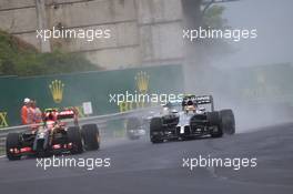 Pastor Maldonado (VEN) Lotus F1 E21 and Kevin Magnussen (DEN) McLaren MP4-29 battle for position. 27.07.2014. Formula 1 World Championship, Rd 11, Hungarian Grand Prix, Budapest, Hungary, Race Day.