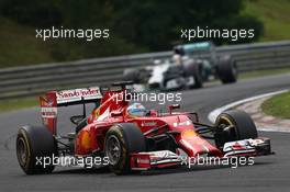 Fernando Alonso (ESP) Ferrari F14-T leads Nico Rosberg (GER) Mercedes AMG F1 W05. 27.07.2014. Formula 1 World Championship, Rd 11, Hungarian Grand Prix, Budapest, Hungary, Race Day.