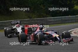 Jean-Eric Vergne (FRA) Scuderia Toro Rosso STR9 leads Jenson Button (GBR) McLaren MP4-29. 27.07.2014. Formula 1 World Championship, Rd 11, Hungarian Grand Prix, Budapest, Hungary, Race Day.
