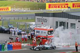 Lewis Hamilton (GBR) Mercedes AMG F1 W05 stops in the pitlane during qualifying after suffering a fire. 26.07.2014. Formula 1 World Championship, Rd 11, Hungarian Grand Prix, Budapest, Hungary, Qualifying Day.