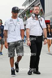 Lewis Hamilton (GBR) Mercedes AMG F1 with Bradley Lord (GBR) Mercedes AMG F1 Communications Manager. 26.07.2014. Formula 1 World Championship, Rd 11, Hungarian Grand Prix, Budapest, Hungary, Qualifying Day.