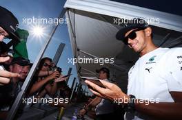 Lewis Hamilton (GBR) Mercedes AMG F1 signs autographs for the fans. 24.07.2014. Formula 1 World Championship, Rd 11, Hungarian Grand Prix, Budapest, Hungary, Preparation Day.