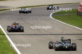 Sebastian Vettel (GER) Red Bull Racing RB10 leads Jenson Button (GBR) McLaren MP4-29. 07.09.2014. Formula 1 World Championship, Rd 13, Italian Grand Prix, Monza, Italy, Race Day.