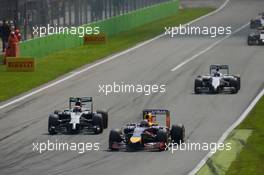 Sebastian Vettel (GER) Red Bull Racing RB10 leads Kevin Magnussen (DEN) McLaren MP4-29. 07.09.2014. Formula 1 World Championship, Rd 13, Italian Grand Prix, Monza, Italy, Race Day.