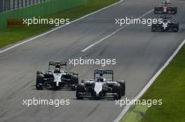 Valtteri Bottas (FIN) Williams FW36 and Kevin Magnussen (DEN) McLaren MP4-29 battle for position. 07.09.2014. Formula 1 World Championship, Rd 13, Italian Grand Prix, Monza, Italy, Race Day.