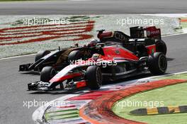 Jules Bianchi (FRA) Marussia F1 Team MR03 and Romain Grosjean (FRA) Lotus F1 E22. 07.09.2014. Formula 1 World Championship, Rd 13, Italian Grand Prix, Monza, Italy, Race Day.