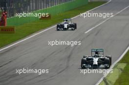 Nico Rosberg (GER) Mercedes AMG F1 W05 leads team mate Lewis Hamilton (GBR) Mercedes AMG F1 W05 who exits the pits. 07.09.2014. Formula 1 World Championship, Rd 13, Italian Grand Prix, Monza, Italy, Race Day.