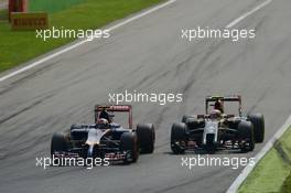 Daniil Kvyat (RUS) Scuderia Toro Rosso STR9 and Pastor Maldonado (VEN) Lotus F1 E21 battle for position. 07.09.2014. Formula 1 World Championship, Rd 13, Italian Grand Prix, Monza, Italy, Race Day.