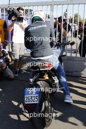 Lewis Hamilton (GBR) Mercedes AMG F1 arrives at the circuit on a motorbike. 06.09.2014. Formula 1 World Championship, Rd 13, Italian Grand Prix, Monza, Italy, Qualifying Day.