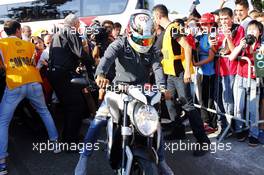 Lewis Hamilton (GBR) Mercedes AMG F1 arrives at the circuit on a motorbike. 06.09.2014. Formula 1 World Championship, Rd 13, Italian Grand Prix, Monza, Italy, Qualifying Day.