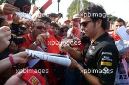 Sergio Perez (MEX) Sahara Force India F1 signs autographs for the fans. 07.09.2014. Formula 1 World Championship, Rd 13, Italian Grand Prix, Monza, Italy, Race Day.
