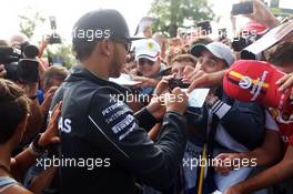 Lewis Hamilton (GBR) Mercedes AMG F1 signs autographs for the fans. 07.09.2014. Formula 1 World Championship, Rd 13, Italian Grand Prix, Monza, Italy, Race Day.
