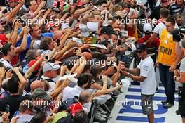 Lewis Hamilton (GBR) Mercedes AMG F1 signs autographs for the fans. 04.09.2014. Formula 1 World Championship, Rd 13, Italian Grand Prix, Monza, Italy, Preparation Day.