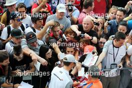 Jenson Button (GBR) McLaren signs autographs for the fans. 04.09.2014. Formula 1 World Championship, Rd 13, Italian Grand Prix, Monza, Italy, Preparation Day.