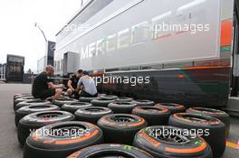 Pirelli tyre technician with McLaren mechanics. 04.09.2014. Formula 1 World Championship, Rd 13, Italian Grand Prix, Monza, Italy, Preparation Day.