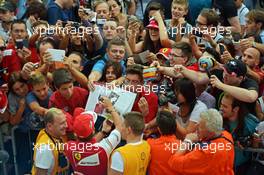 Fernando Alonso (ESP) Ferrari signs autographs for the fans in the pit lane. 04.09.2014. Formula 1 World Championship, Rd 13, Italian Grand Prix, Monza, Italy, Preparation Day.