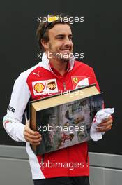 Fernando Alonso (ESP) Ferrari with a large book. 04.09.2014. Formula 1 World Championship, Rd 13, Italian Grand Prix, Monza, Italy, Preparation Day.