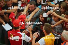 Fernando Alonso (ESP) Ferrari signs autographs for the fans. 04.09.2014. Formula 1 World Championship, Rd 13, Italian Grand Prix, Monza, Italy, Preparation Day.