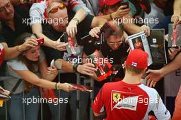 Kimi Raikkonen (FIN) Ferrari signs autographs for the fans. 04.09.2014. Formula 1 World Championship, Rd 13, Italian Grand Prix, Monza, Italy, Preparation Day.