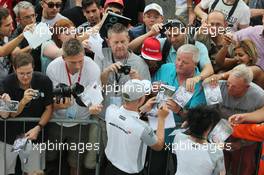 Kevin Magnussen (DEN) McLaren signs autographs for the fans. 04.09.2014. Formula 1 World Championship, Rd 13, Italian Grand Prix, Monza, Italy, Preparation Day.
