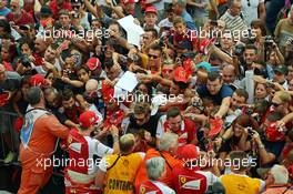 (L to R): Kimi Raikkonen (FIN) Ferrari and team mate Fernando Alonso (ESP) Ferrari sign autographs for the fans in the pit lane. 04.09.2014. Formula 1 World Championship, Rd 13, Italian Grand Prix, Monza, Italy, Preparation Day.