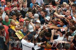 Lewis Hamilton (GBR) Mercedes AMG F1 signs autographs for the fans. 04.09.2014. Formula 1 World Championship, Rd 13, Italian Grand Prix, Monza, Italy, Preparation Day.