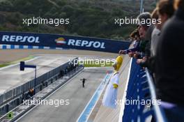 A Homer Simpson toy is dangled above the pit lane by a fan. 29.01.2014. Formula One Testing, Day Two, Jerez, Spain.