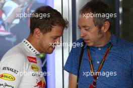 (L to R): Sebastian Vettel (GER) Red Bull Racing with Mark Thompson (GBR) Getty Images Photographer. 03.10.2014. Formula 1 World Championship, Rd 15, Japanese Grand Prix, Suzuka, Japan, Practice Day.