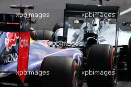 Lewis Hamilton (GBR) Mercedes AMG F1 W05 and Sebastian Vettel (GER) Red Bull Racing RB10 at the end of the pit lane. 03.10.2014. Formula 1 World Championship, Rd 15, Japanese Grand Prix, Suzuka, Japan, Practice Day.