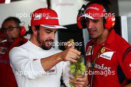(L to R): Fernando Alonso (ESP) Ferrari with Marc Gene (ESP) Ferrari Test Driver. 03.10.2014. Formula 1 World Championship, Rd 15, Japanese Grand Prix, Suzuka, Japan, Practice Day.